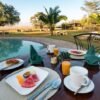 Colorful fruit platter by the pool at a Mombasa beach lodge during a 3 Days Mombasa Package
