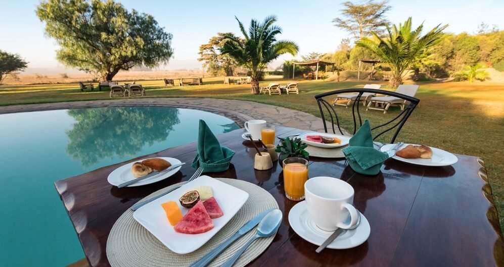 Colorful fruit platter by the pool at a Mombasa beach lodge during a 3 Days Mombasa Package