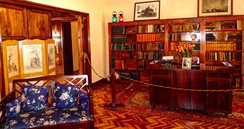 A preserved room inside the Karen Blixen Museum during the 1-Day Karen Blixen Museum Day Trip, showcasing original furniture and décor