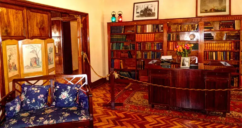A preserved room inside the Karen Blixen Museum during the 1-Day Karen Blixen Museum Day Trip, showcasing original furniture and décor