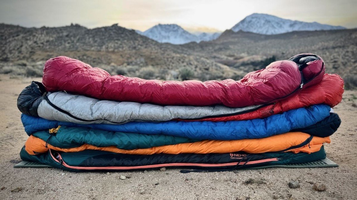 Stacked sleeping bags inside a tent, ready for mountain camping adventures.