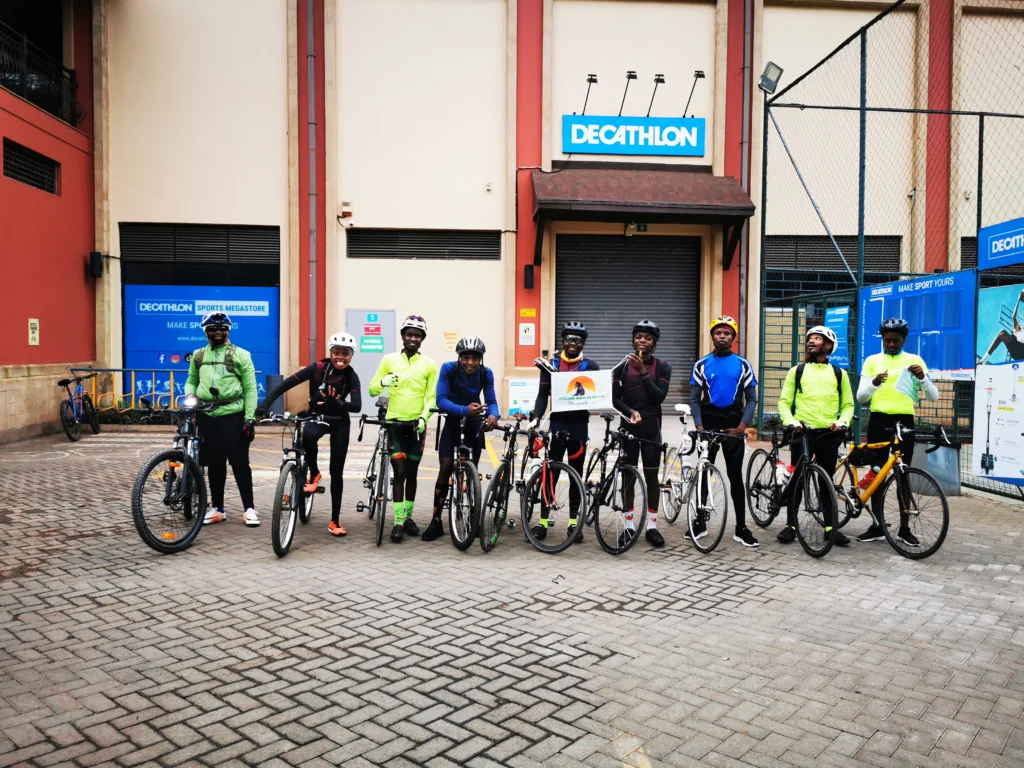 Group of cyclists posing before the Namanga ride during a Kenya Adventure Tour with Wild Pro Adventures