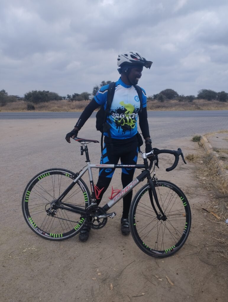 Client posing with a bike during a Kenya Adventure Tour with Wild Pro Adventures