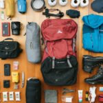 Essential mountaineering gear laid out for a fearless adventure, including ropes, helmets, harnesses, boots, and climbing equipment.