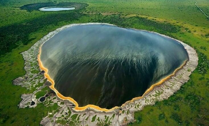 Aerial view of Ngorongoro Crater in Tanzania showing the vast volcanic caldera and surrounding grasslands.